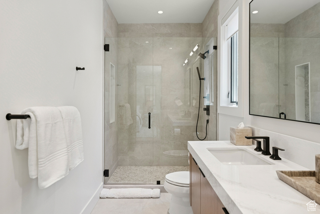 Full bathroom with vanity, a shower stall, and recessed lighting