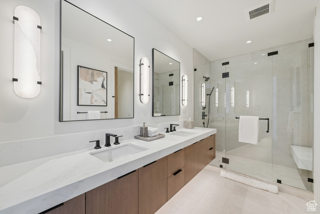 Bathroom with double vanity, a stall shower, recessed lighting, and tile patterned flooring