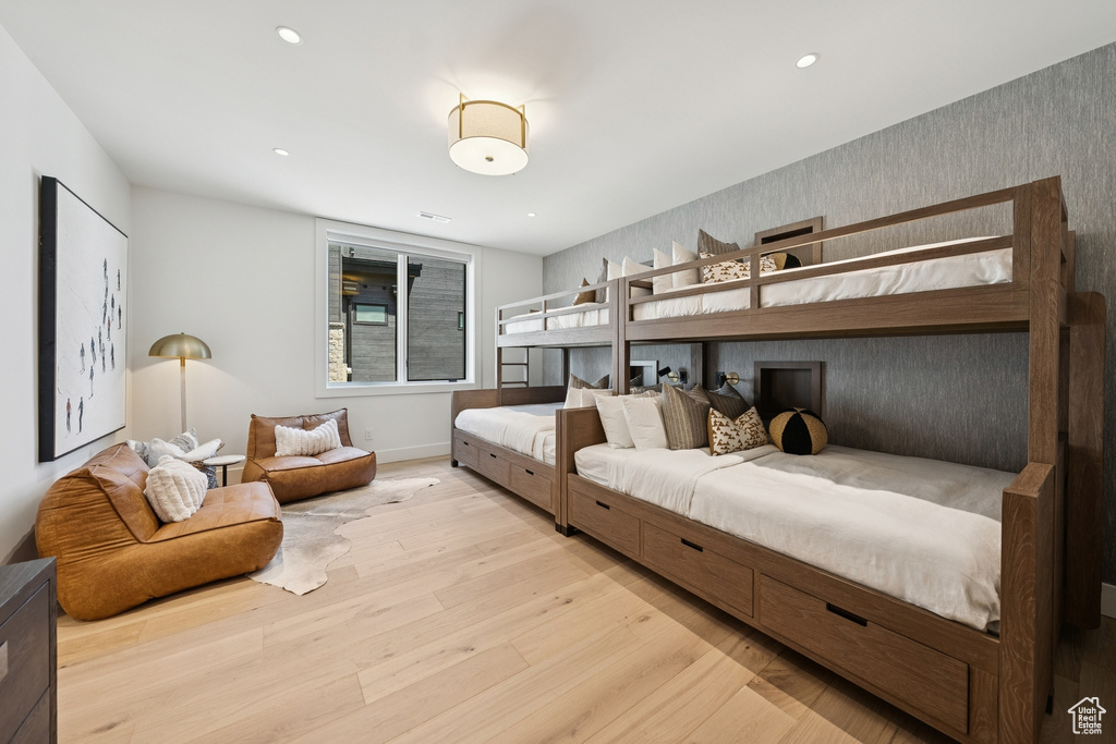 Bedroom featuring light wood-type flooring, wallpapered walls, and recessed lighting