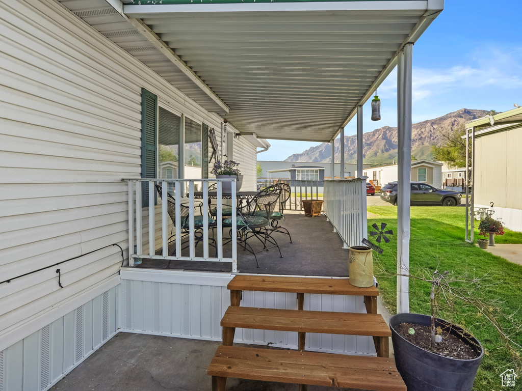 View of patio / terrace featuring outdoor dining area and a deck with mountain view