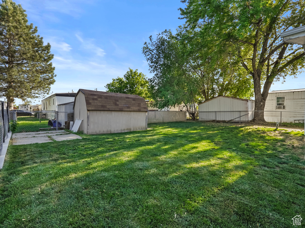 View of yard featuring a storage shed and an outdoor structure