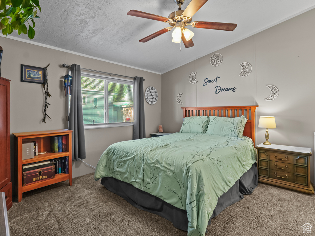 Bedroom featuring carpet, crown molding, and ceiling fan