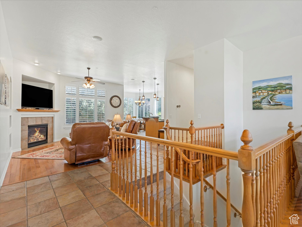 Hallway featuring an upstairs landing and a chandelier