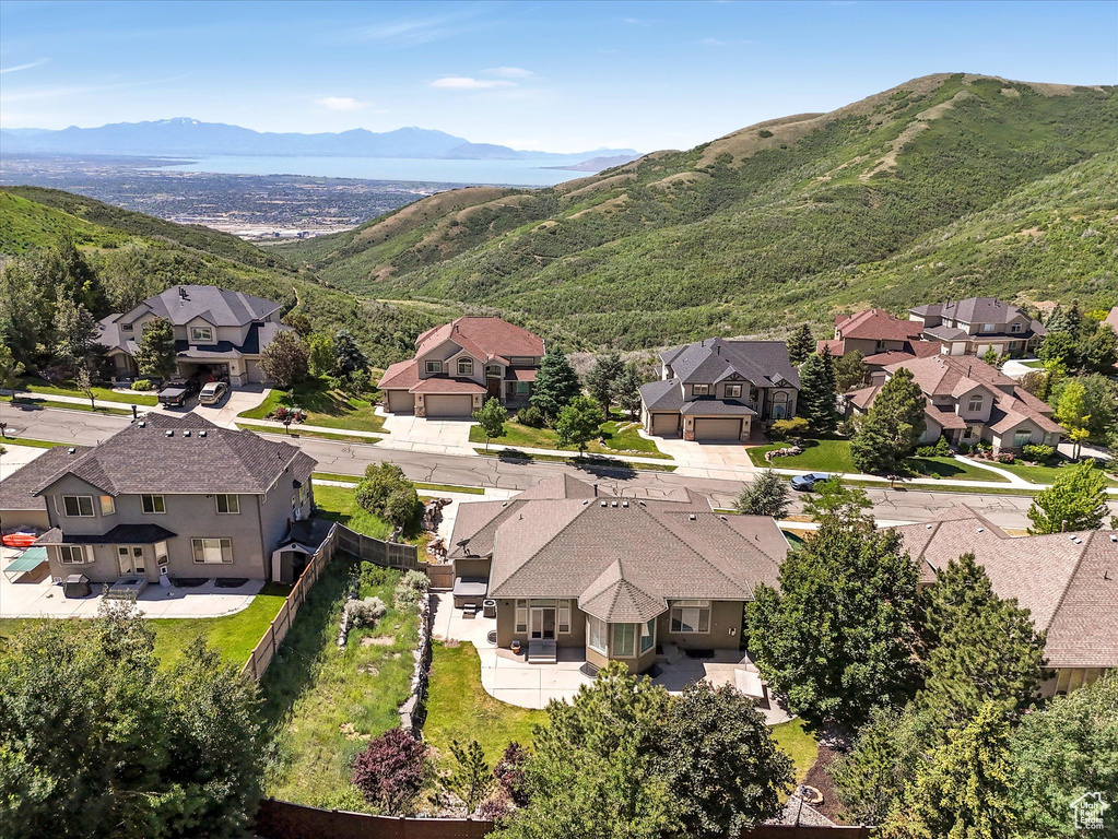 Aerial perspective of suburban area featuring a mountainous background