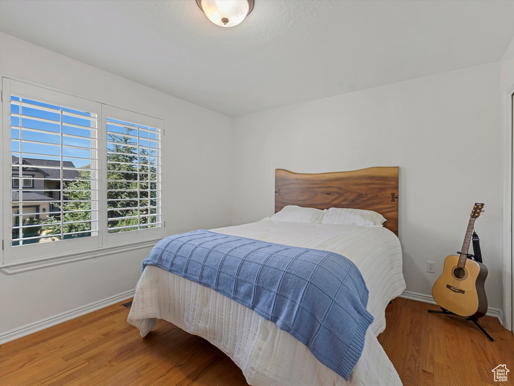 Bedroom featuring baseboards and wood finished floors