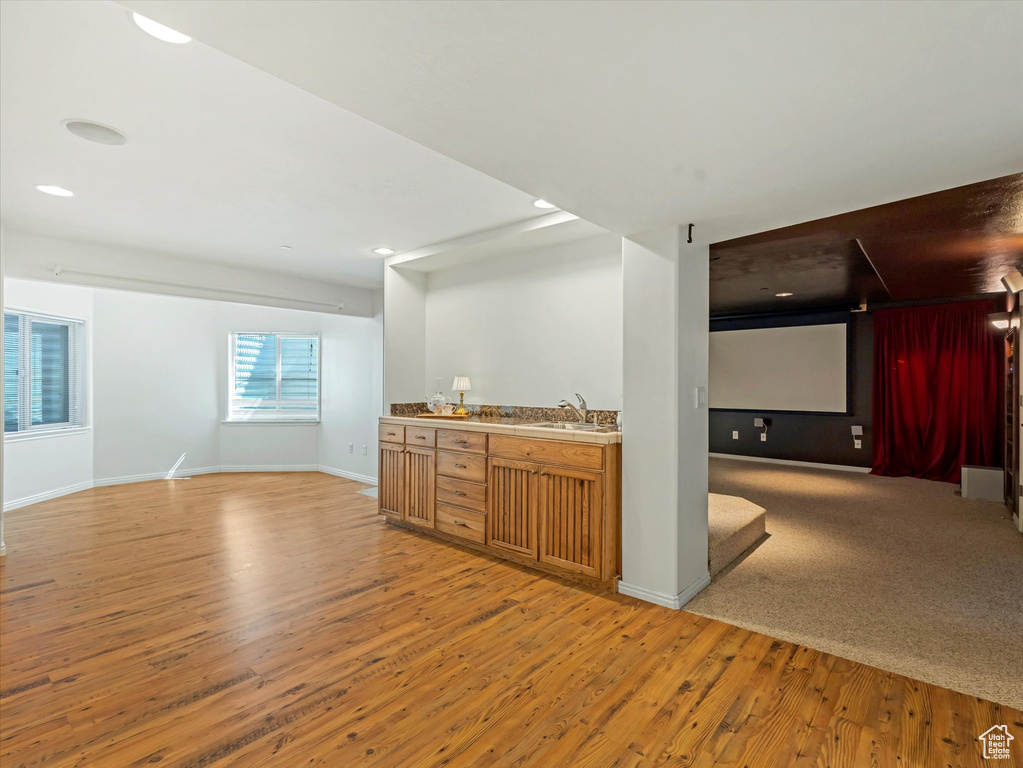 Indoor wet bar featuring light wood-style flooring and recessed lighting