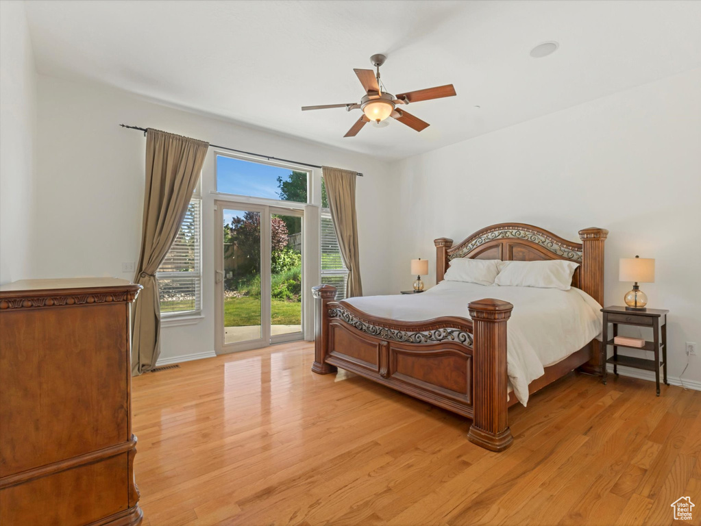 Bedroom with access to exterior, light wood-type flooring, and a ceiling fan