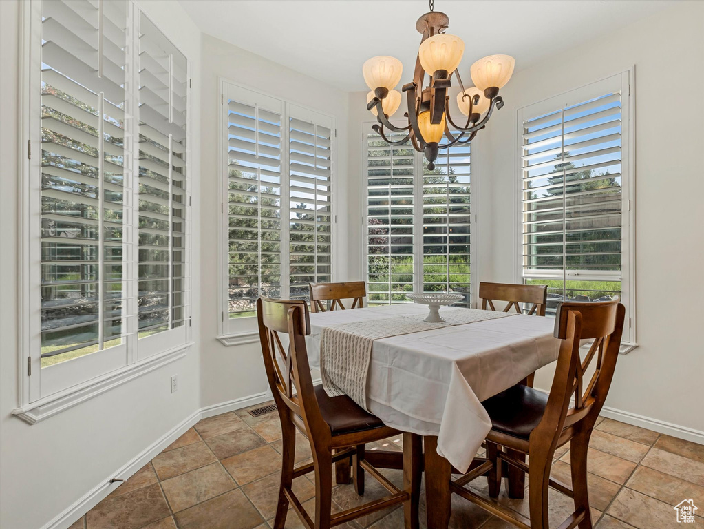 Dining space with a chandelier and baseboards