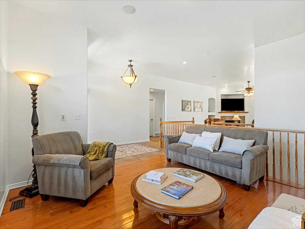 Living area featuring ceiling fan and light wood finished floors