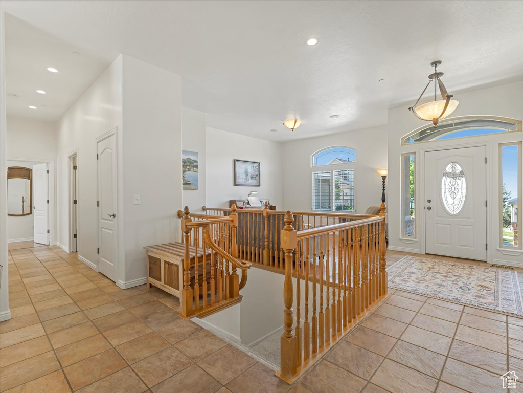 Entrance foyer with recessed lighting and light tile patterned floors