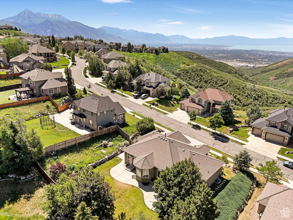 Aerial view of residential area featuring a mountainous background