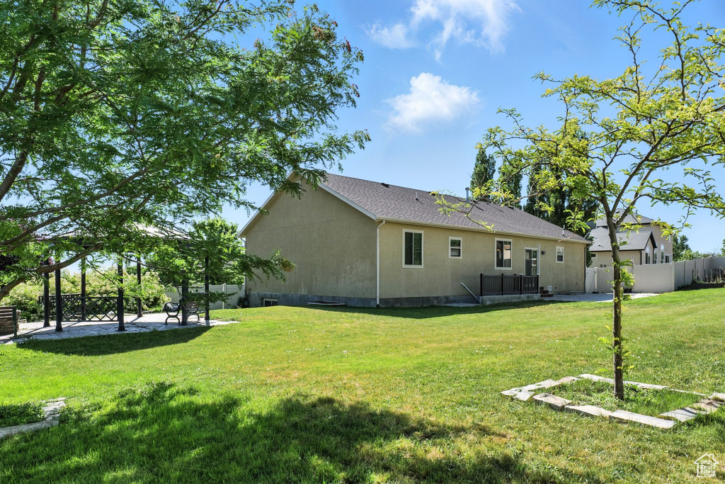 Rear view of property with stucco siding and a patio