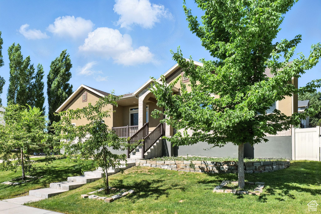 View of front of house featuring stucco siding and stairs