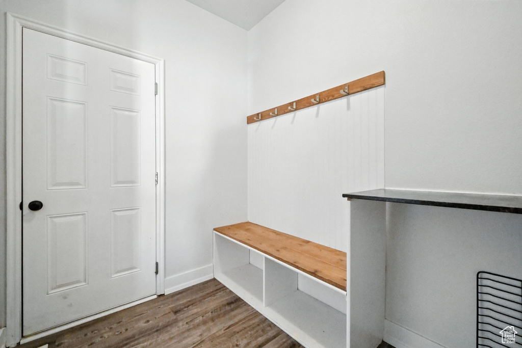 Mudroom featuring wood finished floors and baseboards