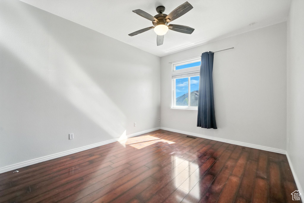 Empty room featuring hardwood / wood-style flooring and a ceiling fan