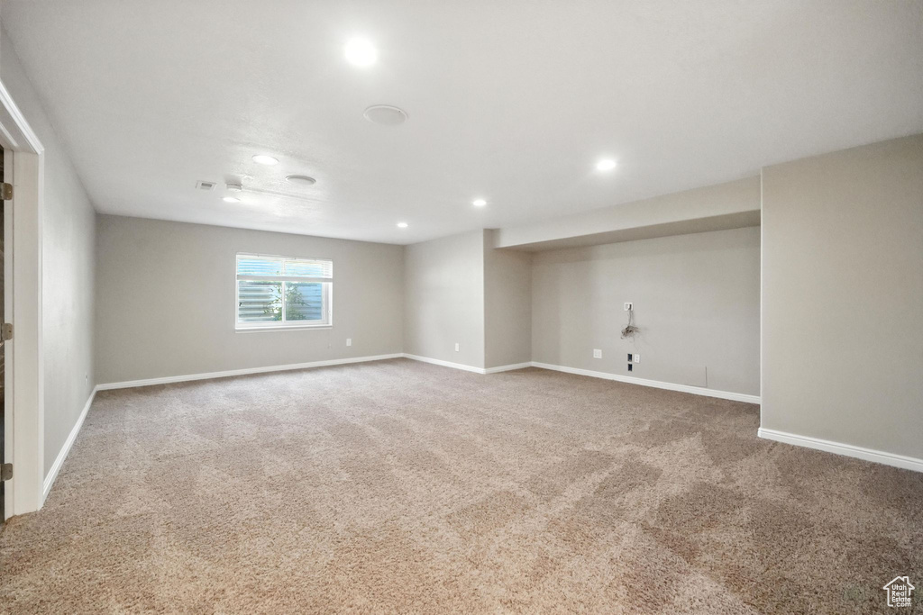 Carpeted empty room featuring recessed lighting and baseboards