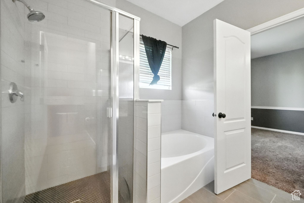 Bathroom with a bath, a stall shower, and tile patterned floors