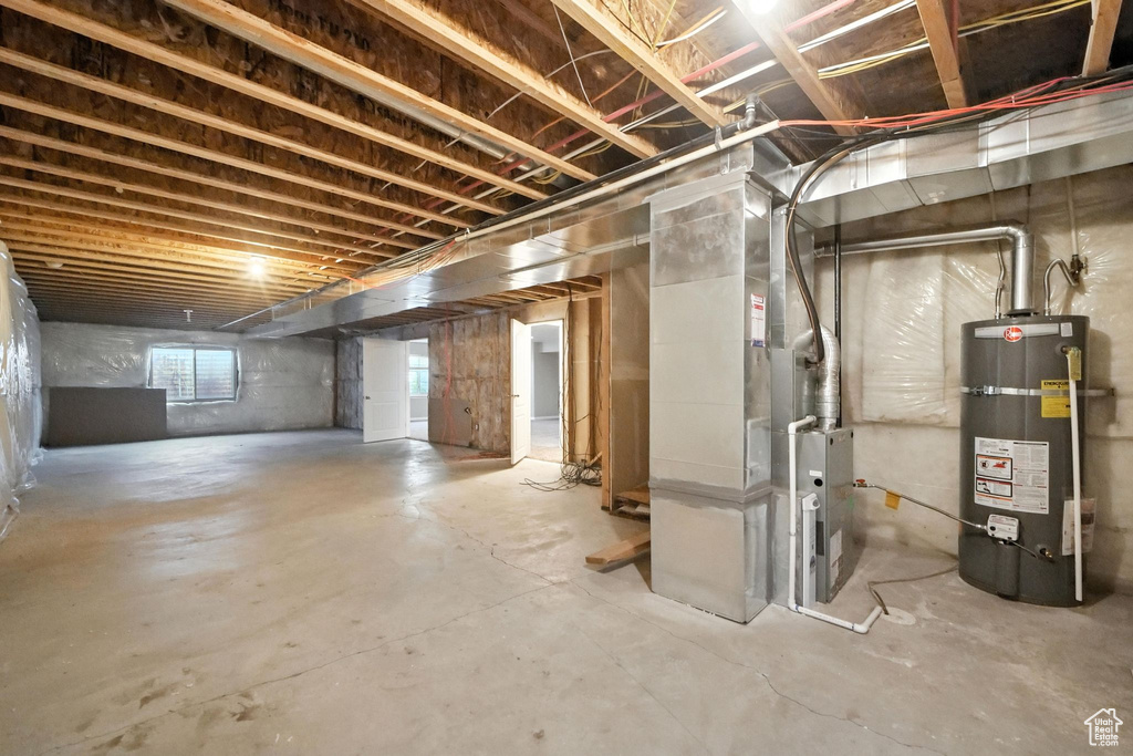Below grade area featuring secured water heater and heating unit