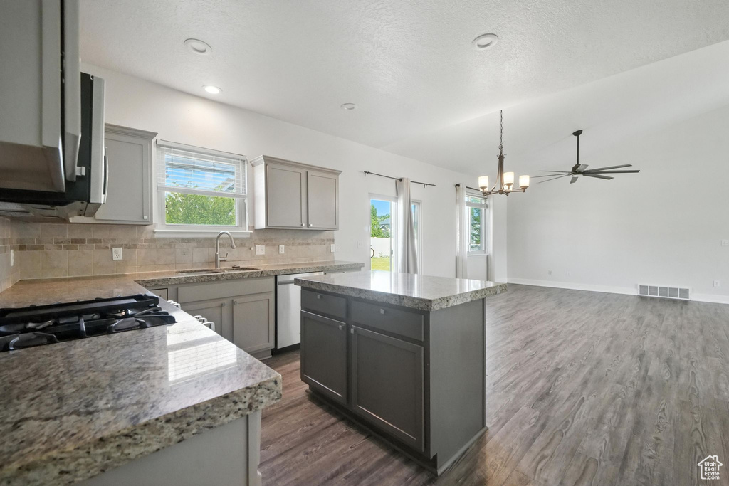 Kitchen with gray cabinetry, dishwasher, dark wood-style floors, decorative backsplash, and recessed lighting