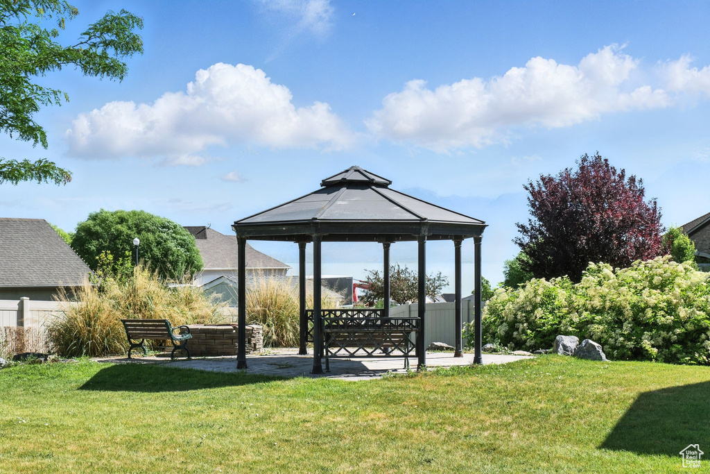 View of green lawn featuring a gazebo and a patio area