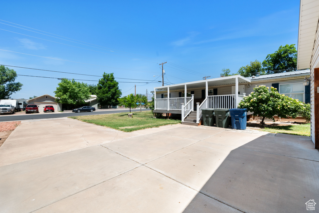 View of front of home with covered porch and concrete driveway