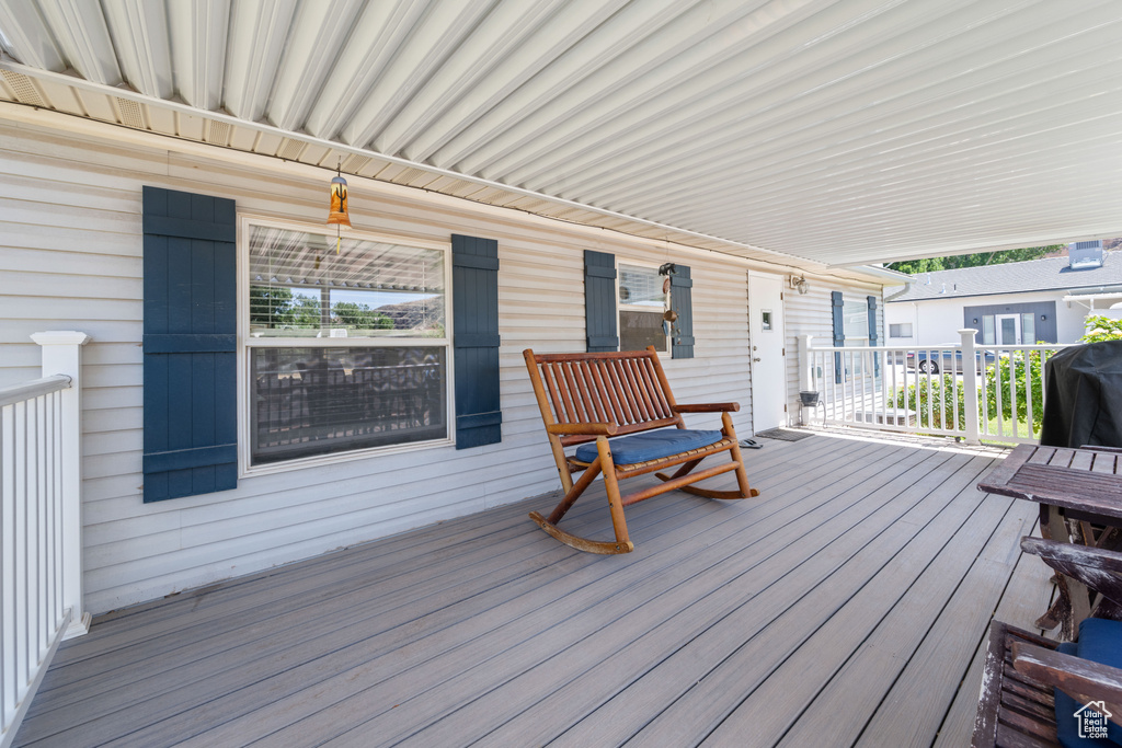 Wooden porch featuring area for grilling