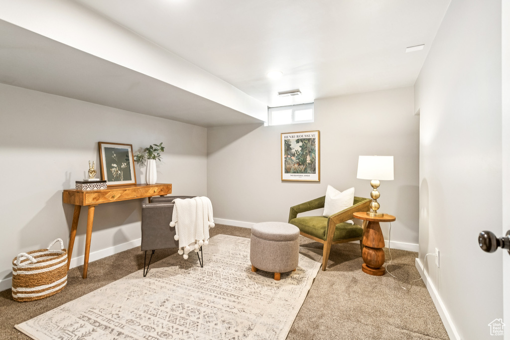 Carpeted office space with baseboards