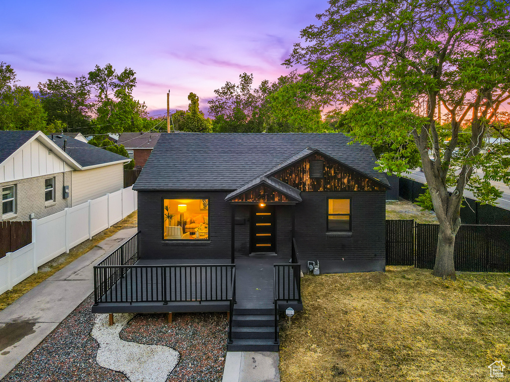 View of front of property featuring roof with shingles and a fenced backyard