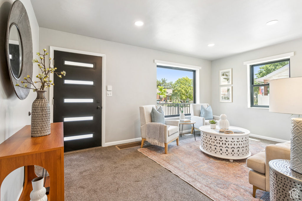 Entryway with carpet floors and recessed lighting