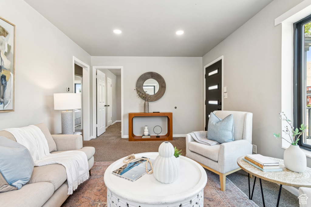 Carpeted living room featuring recessed lighting and baseboards