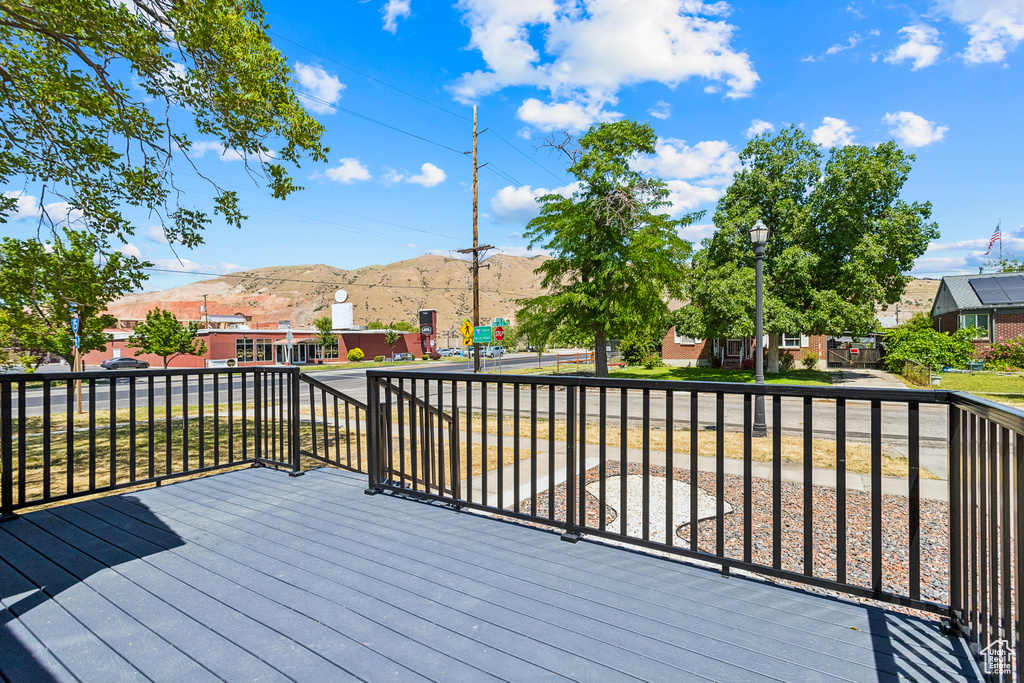 Wooden terrace featuring a mountain view