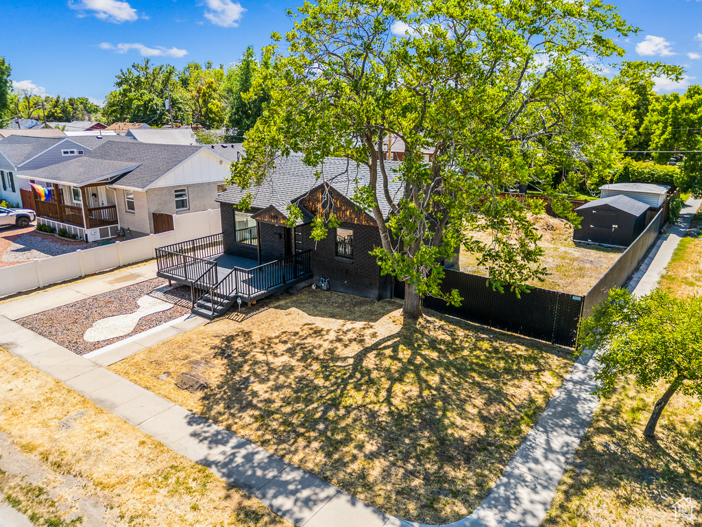 View of front of property featuring a wooden deck and a residential view