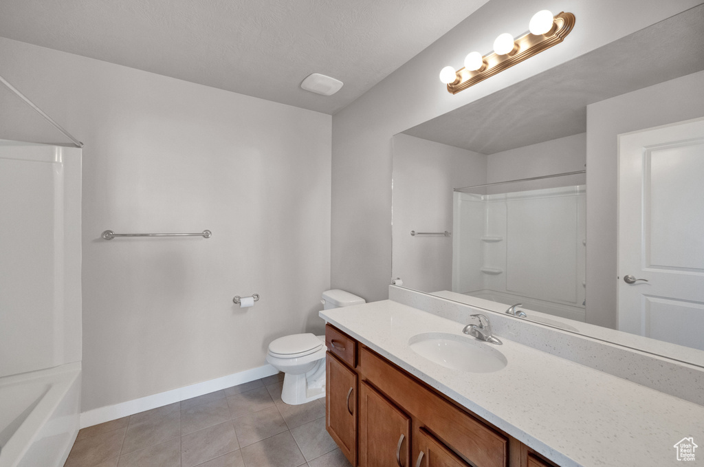 Bathroom with vanity, tile patterned floors, and shower / tub combination