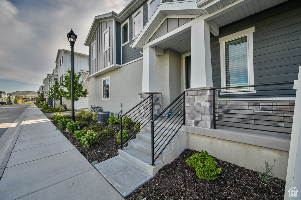 Entrance to property with stucco siding, stone siding, and a residential view