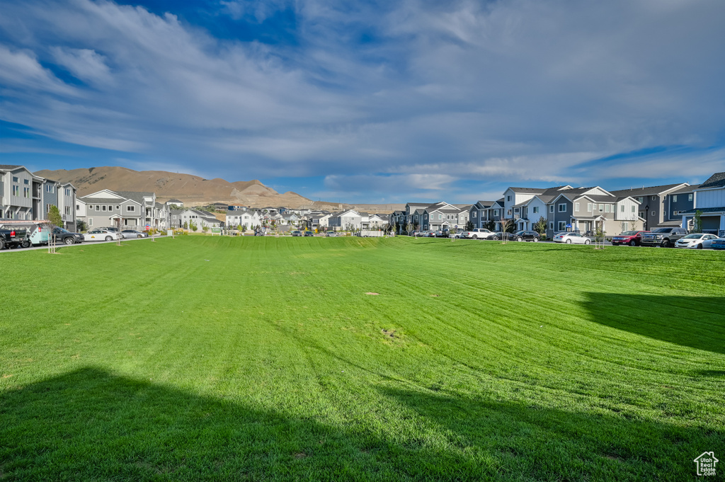View of community with a residential view, a yard, and a mountain view