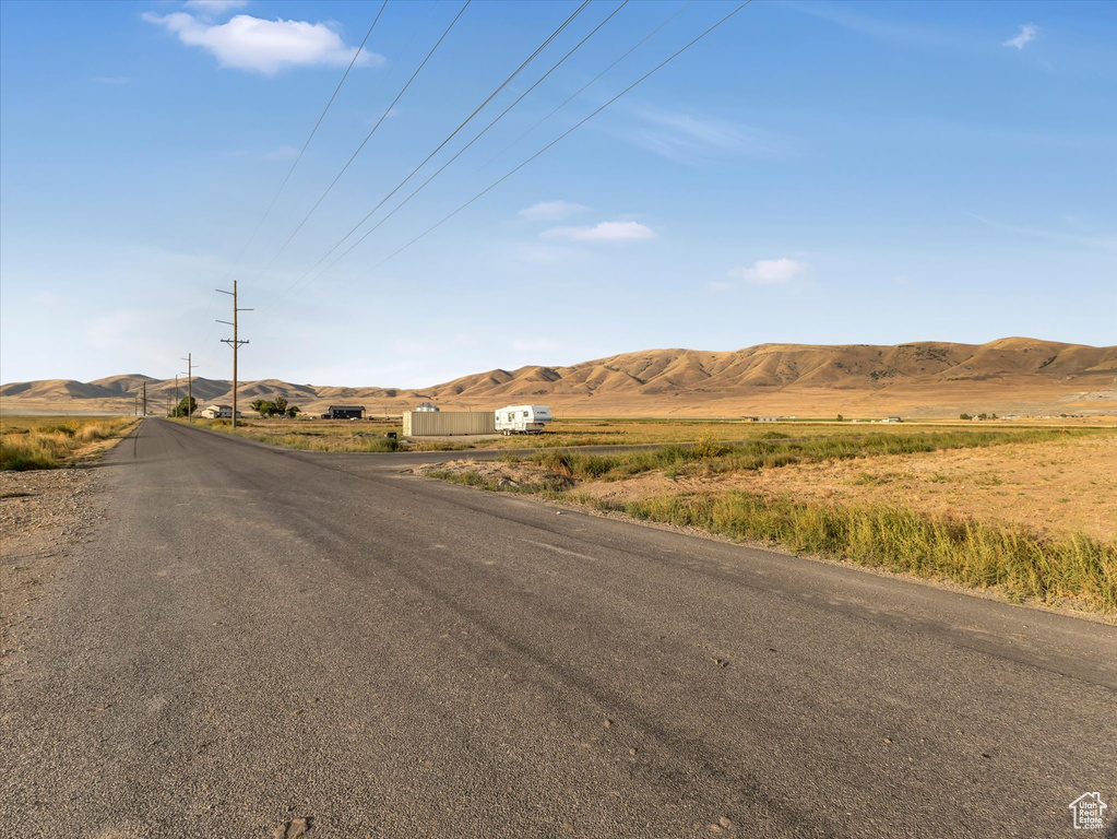 View of asphalt street featuring a mountain view and a view of countryside