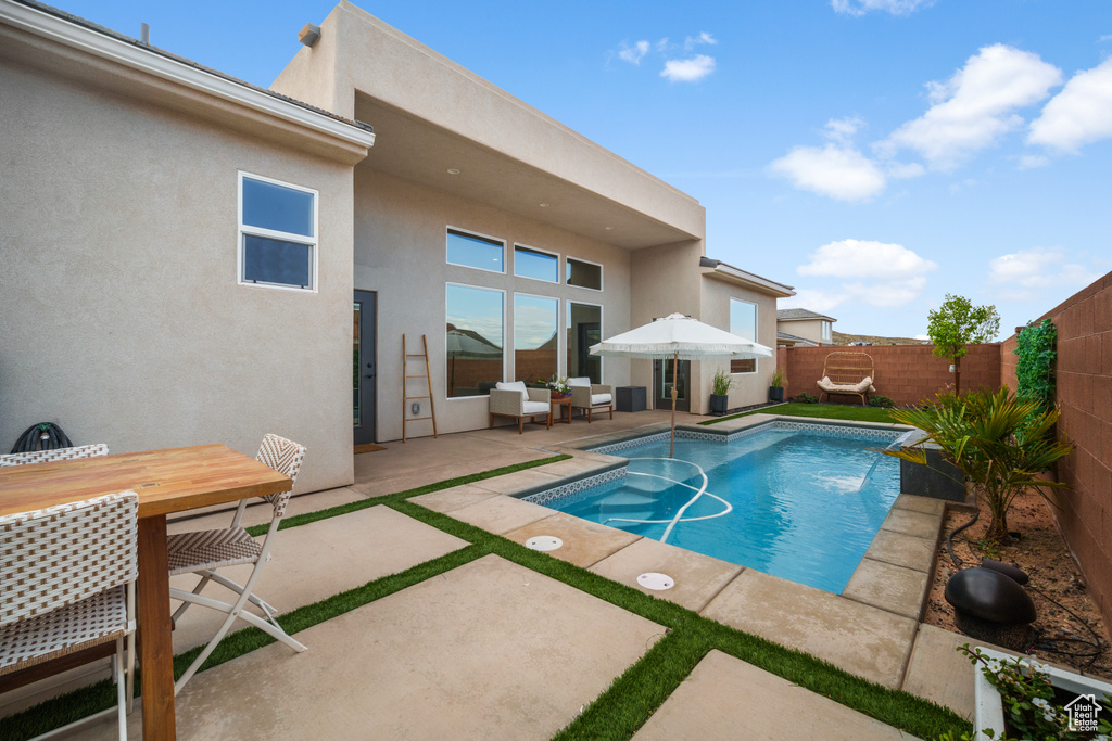 View of swimming pool with a patio area, a fenced backyard, an outdoor living space, and outdoor dining area