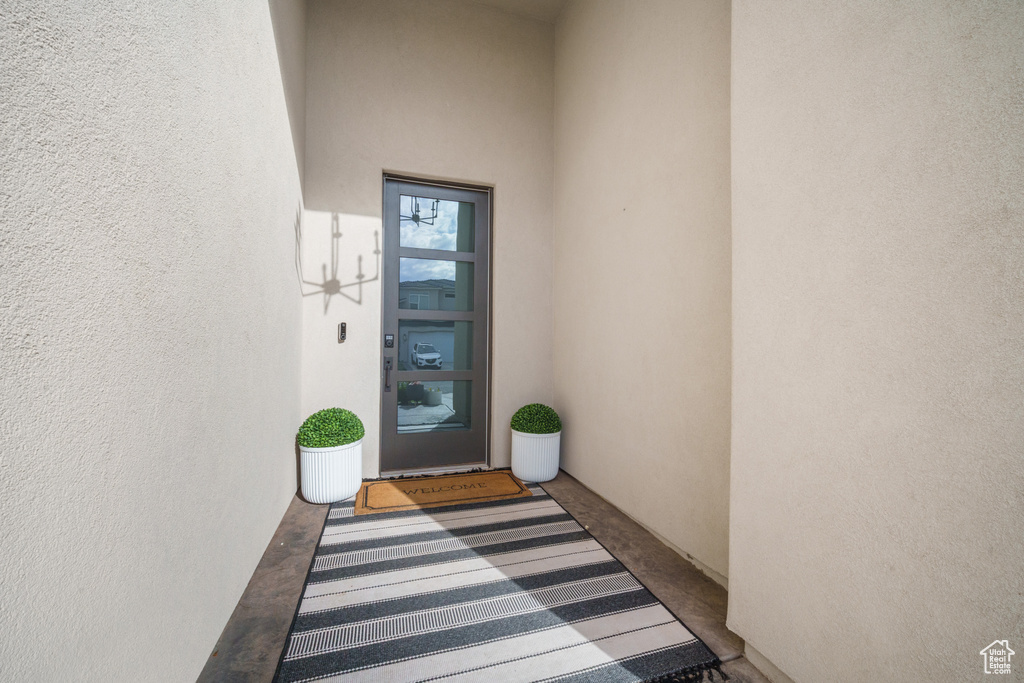 View of exterior entry featuring stucco siding