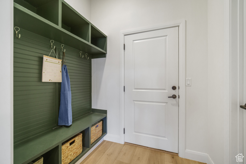 Mudroom featuring light wood-type flooring and baseboards