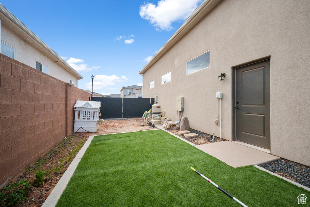 Fenced backyard featuring a patio