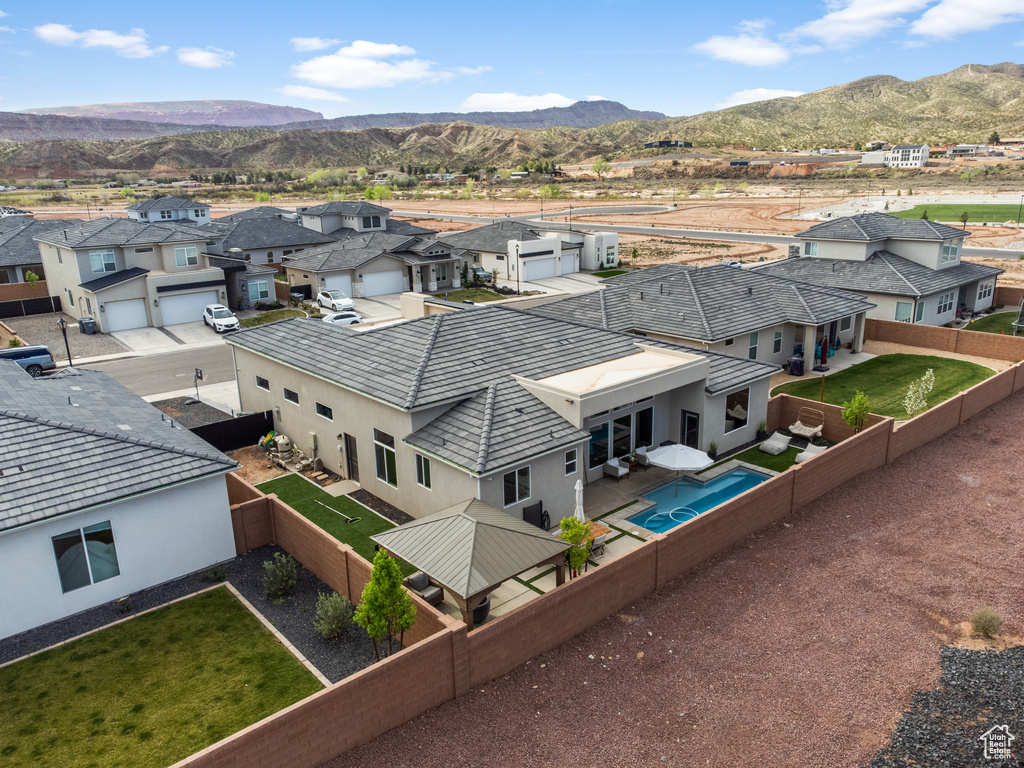 Aerial perspective of suburban area with a mountainous background