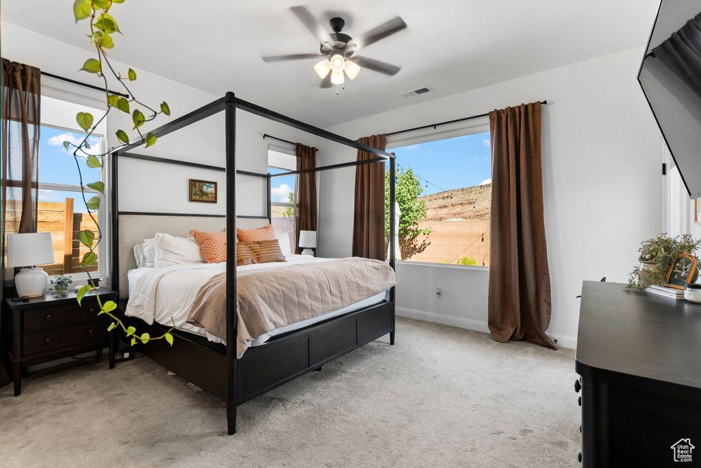 Bedroom featuring light carpet and ceiling fan