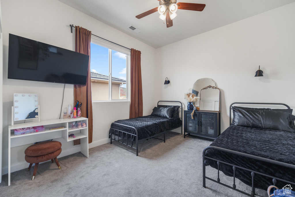 Carpeted bedroom featuring a ceiling fan and baseboards