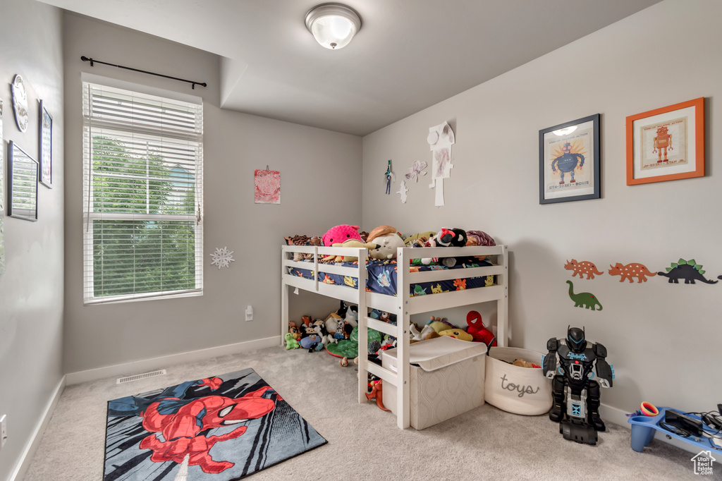 Bedroom featuring carpet and baseboards