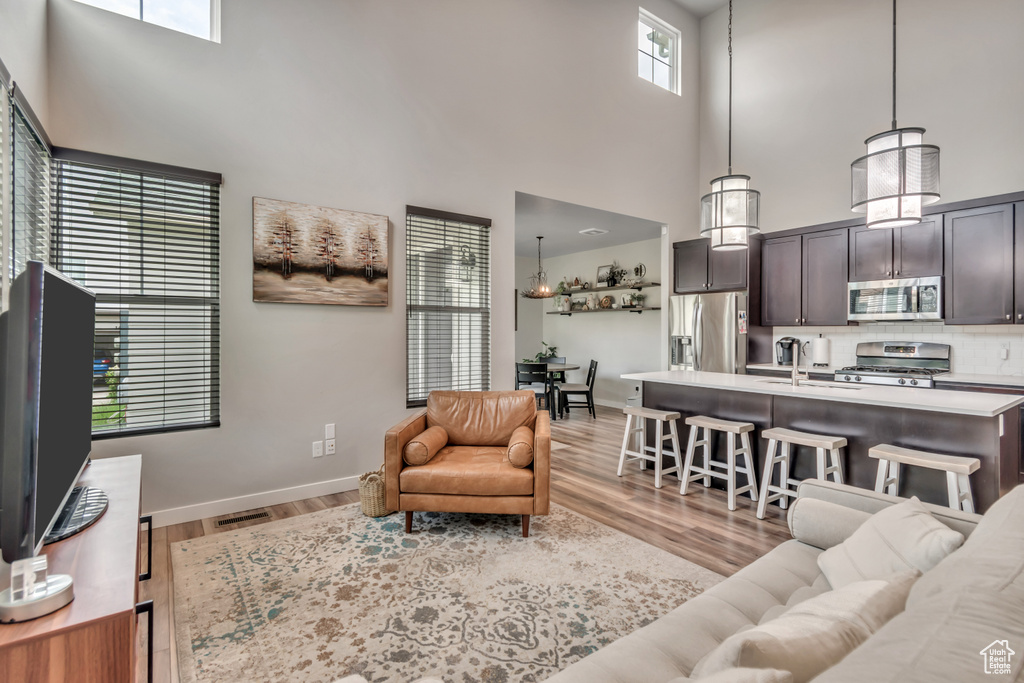 Living area featuring a high ceiling and light wood finished floors