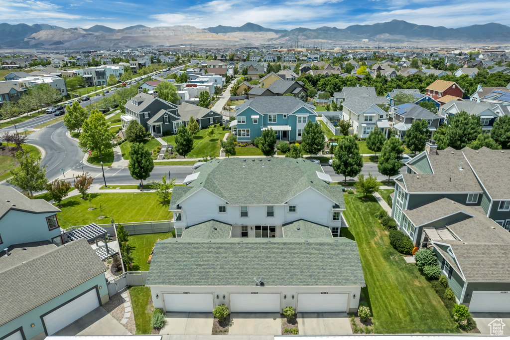 Aerial perspective of suburban area featuring a mountainous background