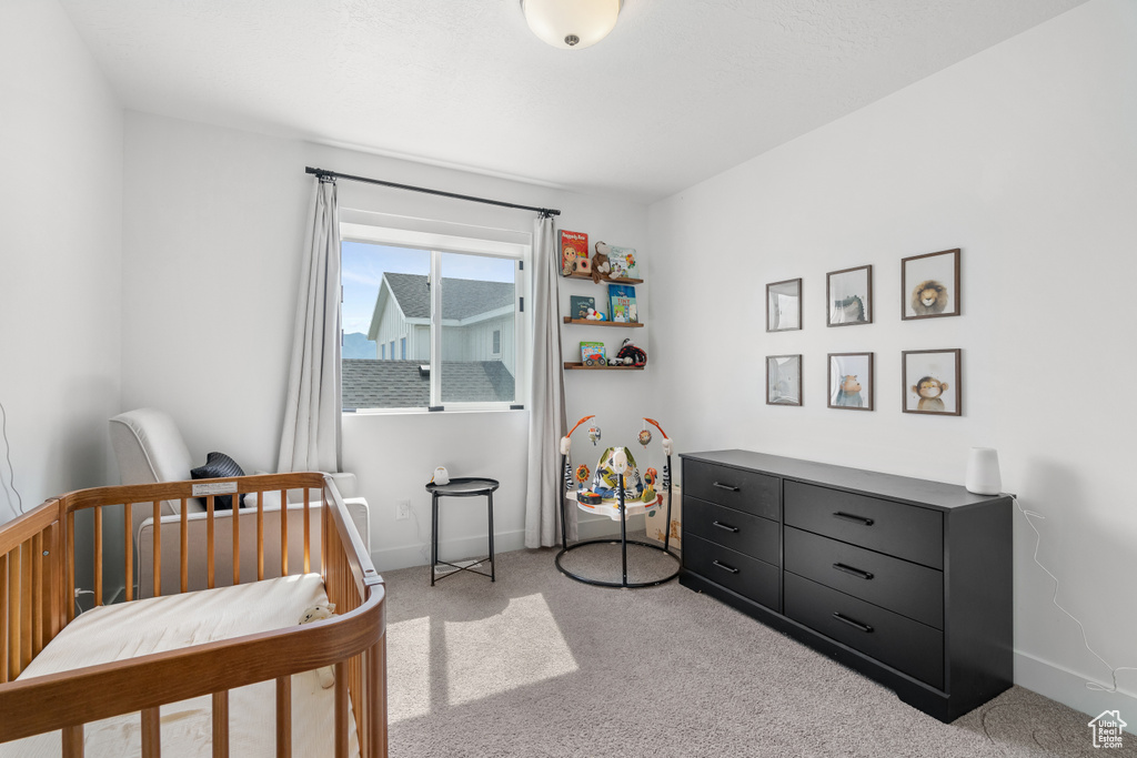 Bedroom featuring carpet floors and baseboards