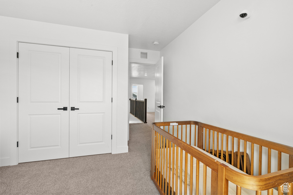 Carpeted bedroom with a closet