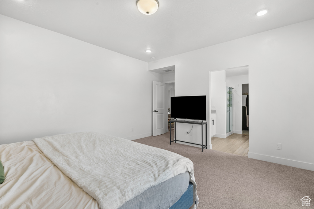 Bedroom with light carpet and recessed lighting