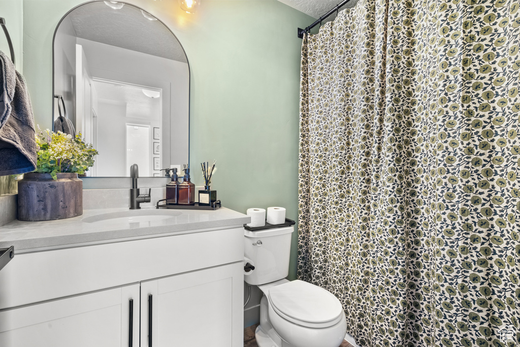 Full bath featuring vanity and curtained shower